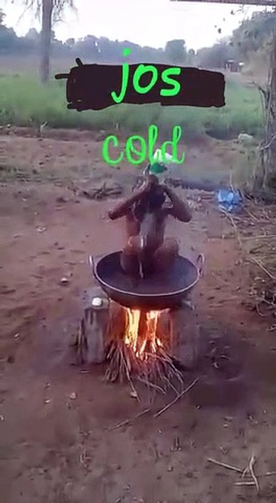 BOY TAKING HIS BIRTH ON A FRYING PAN ON THE  BURNING FIRE