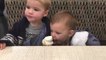 Toddler Slyly Attempts to Lick Ice Cream Cone in Elder Brother's Hand