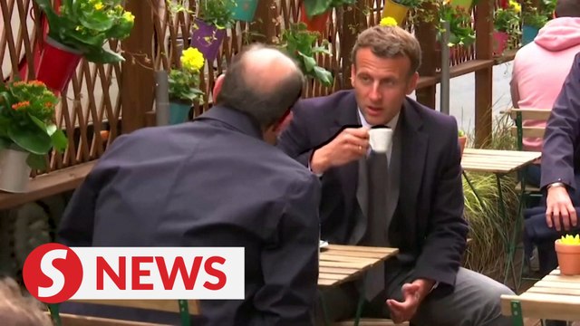 France's Macron out in the cafe after Covid-19 restrictions are eased