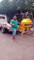 Man Loads Concrete Mixer into a Truck by Himself