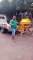 Man Loads Concrete Mixer into a Truck by Himself
