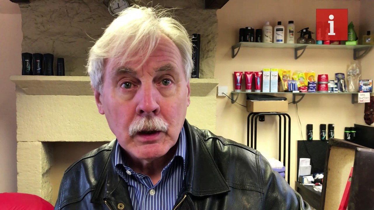 Barber David Adams tries to clean up his Mytholmroyd shop following flood damage by Storm Ciara