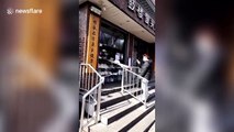 Beijing shop uses DIY slide to hand over food at safe distance amid coronavirus outbreak
