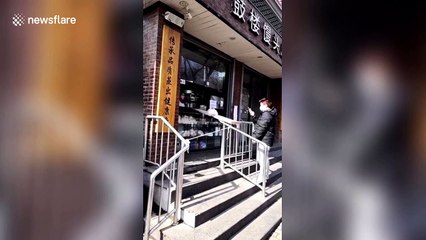 Download Video: Beijing shop uses DIY slide to hand over food at safe distance amid coronavirus outbreak