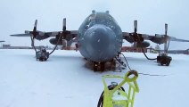 US Air Force - C-130 Hercules on the Flight Line During a Snow Storm