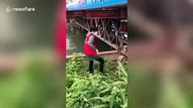 Chinese woman climbs over guardrails into river after being refused passage through coronavirus checkpoint