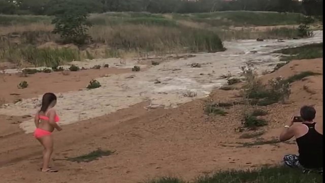 Water flows down a dry riverbed for the first time in YEARS after heavy rains