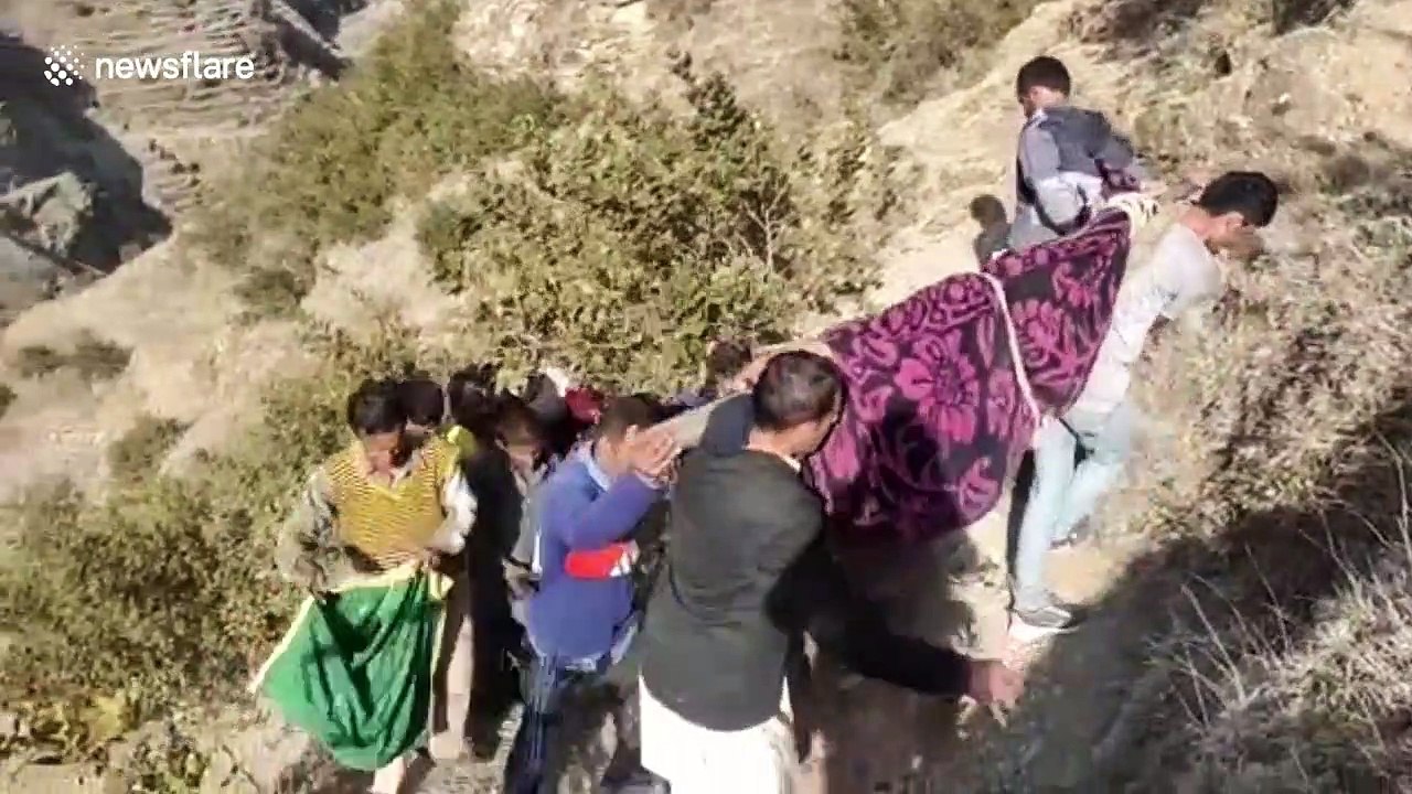 Indian villagers make 10km mountain trek carrying sick man to hospital due to stalled road building