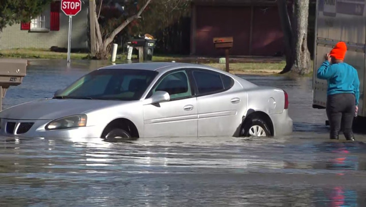 Woman stuck in flood water