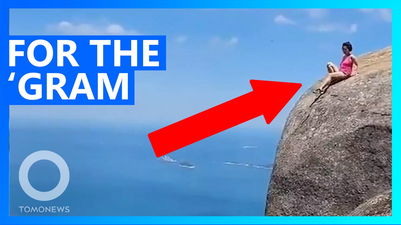 Tourist takes risky shot on the edge of Rio cliff