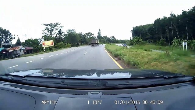 Car narrowly misses motorcycle suddenly changing its lane on Thai highway