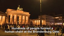 Berliners form human chain at the Brandenburg Gate after Hanau shooting