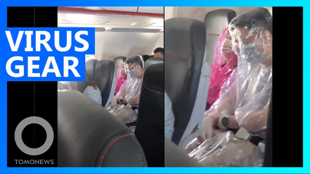 Plane passengers spotted traveling in full-body plastic suits