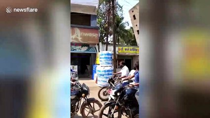 Terrifying footage shows moment two-storey building completely collapses next to busy Indian street