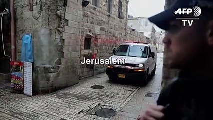 Israeli forces gather where a suspect armed with knife was killed