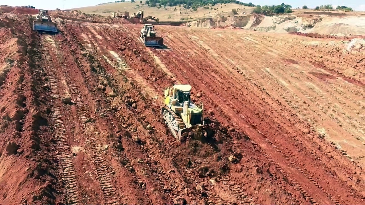 Three Bulldozers Cat D9R And Komatsu D275 Pushing Soil