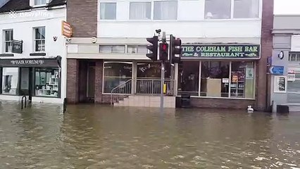 Kayaker seen on UK road as floods hit country