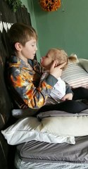 Older Brother Comforting Baby Sister