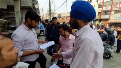 Officials explaining the process to claim compensation to riot victims