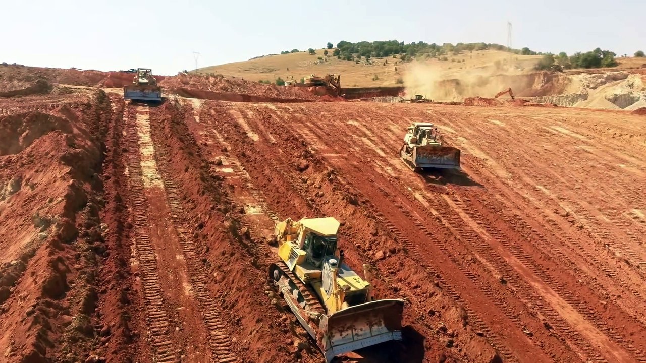 Two Cat D9R And Komatsu D275AX Bulldozers Pushing Soil