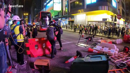 Hong Kong police fire tear gas as protesters return to streets despite coronavirus fears