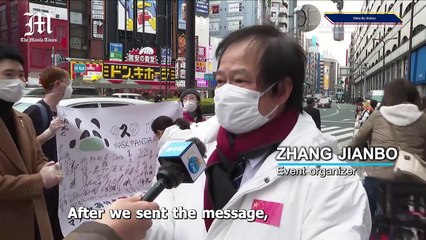 Chinese, Japanese give out masks for free in Tokyo