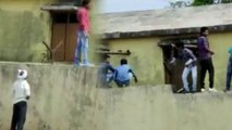 People climbing the boundary walls and providing chits to students | Oneindia Kannada