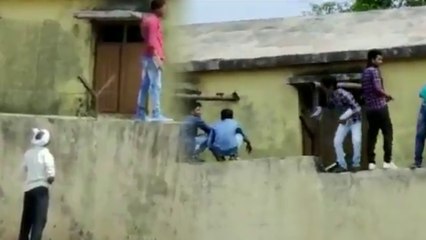 People climbing the boundary walls and providing chits to students | Oneindia Kannada