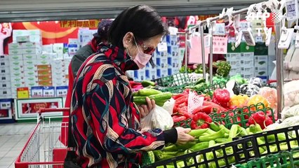 Temperature checks and protective suits at Beijing supermarket