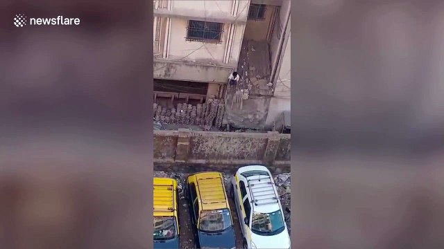 Criminal suspect seen escaping from police building out toilet window in west India