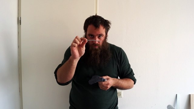 Old time strongman bending a 4 mm x 100 mm nail