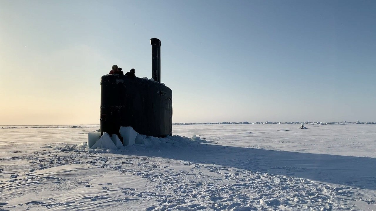 US Navy Submarine Surfaces through the Ice during Ice Exercise 2020