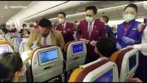 Thai Airways cabin crew wrestle Chinese passenger into her seat after she 'deliberately COUGHED at them'