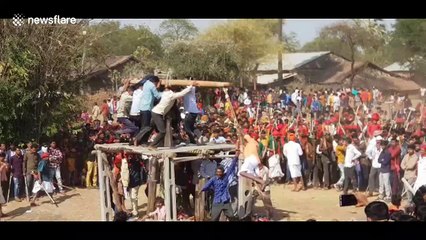 Man spun round at dangerous speeds using bamboo crane at Indian festival