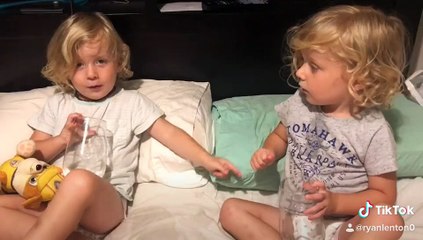 Young Twins Argue Over Who Spilled the Water