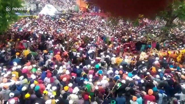 Eight injured when giant flag pole falls on Indian Holi festival crowds