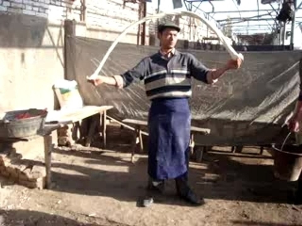 Uighur man makes fresh noodles