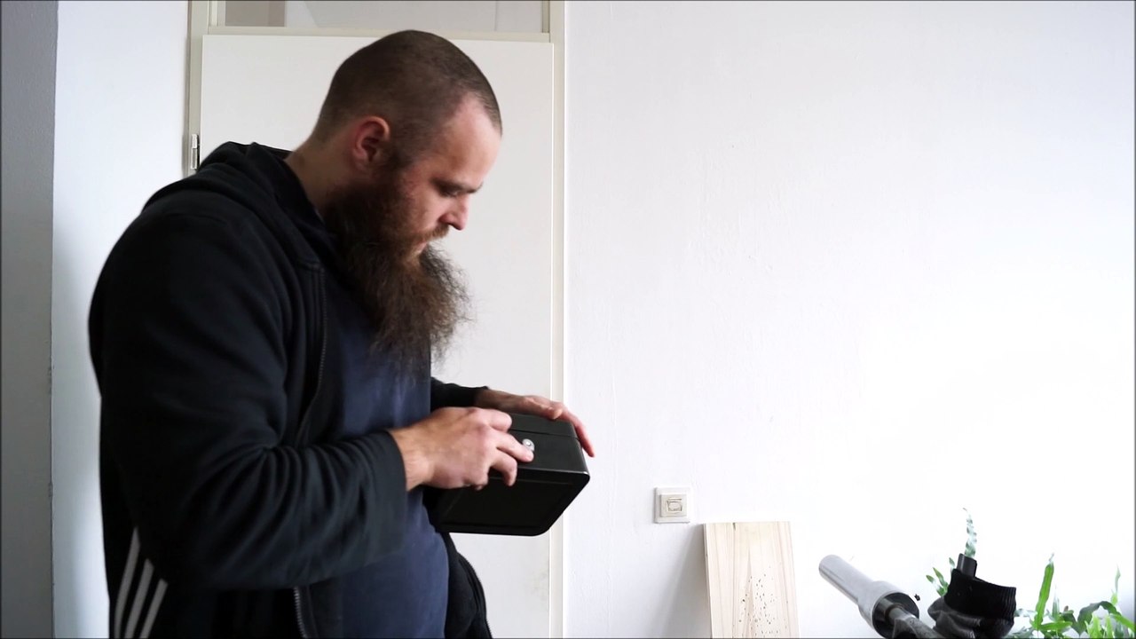 Breaking a cheap metalic money box open with the hands