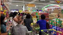 Shoppers queue in supermarket during panic-buying spree in Bangkok