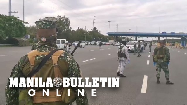 Authorities secure the checkpoint in Cavitex as enhanced community quarantine takes effect