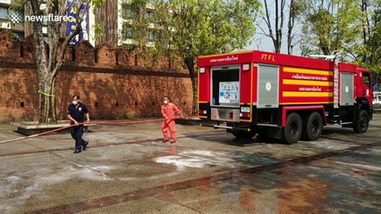Firefighters spray popular tourist spots with disinfectant in Thailand