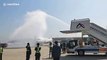 Chinese airport welcomes home flight carrying coronavirus medical workers with water arch