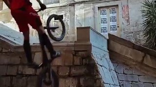 Guy Expertly Rides Bike Over Handrail of Stairs in the Stree