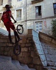 Guy Expertly Rides Bike Over Handrail of Stairs in the Stree