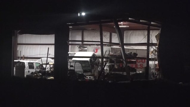 Tornado-warned storm rips up trees, damages building