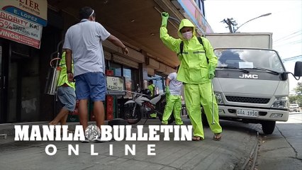 Village officials of San Jose wearing protective suits