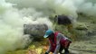 Indonesian miners work in clouds of poisonous gas as they mine sulphur from volcano crater