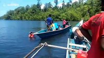 Indonesian villagers attempt to lure stranded blue whale back to deeper waters