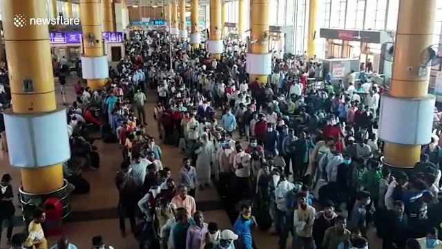 Migrant workers flood Mumbai train station to return home following city-wide curfew