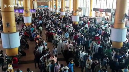 Migrant workers flood Mumbai train station to return home following city-wide curfew